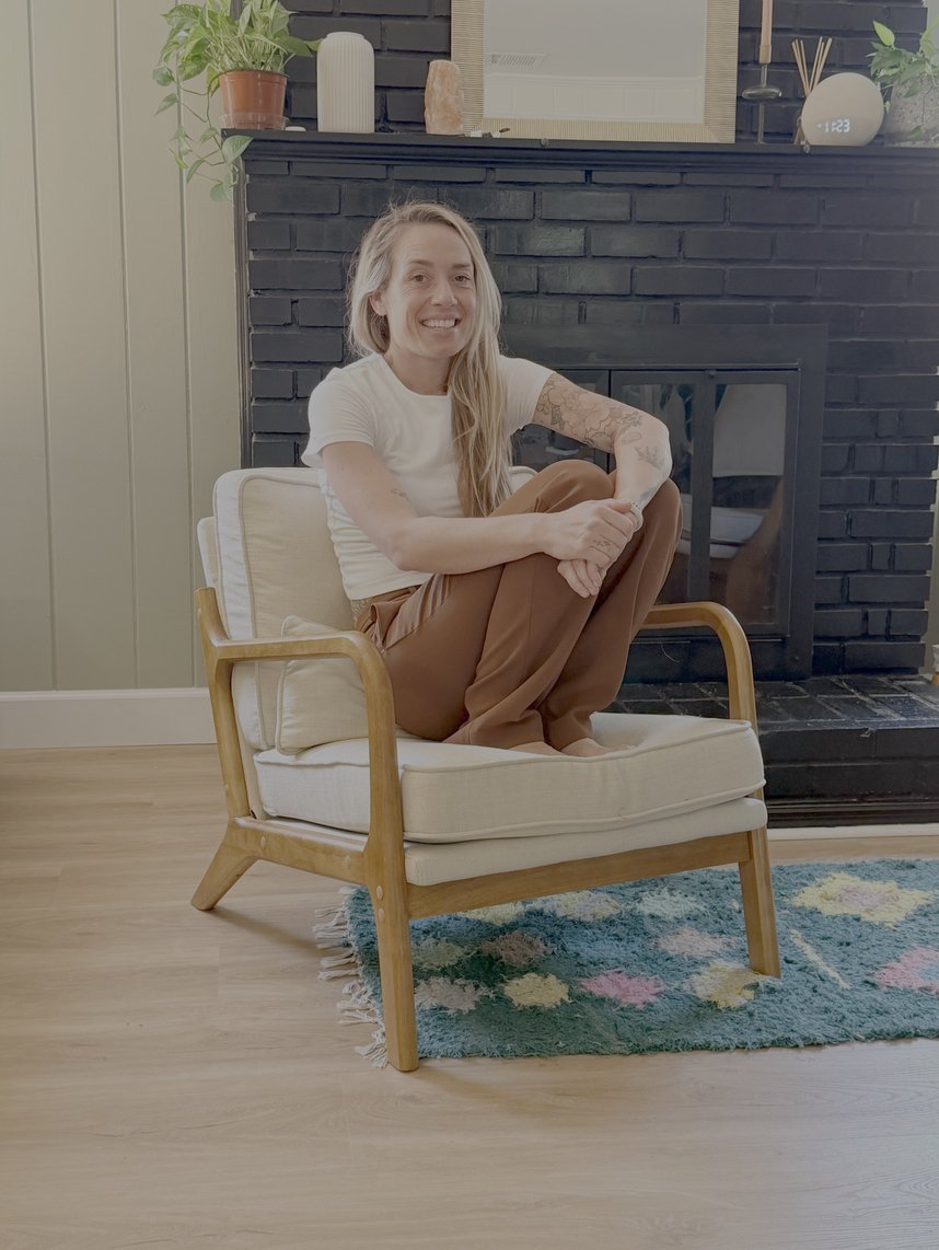 Ash Bergeron seated in a warm, sunlit living room