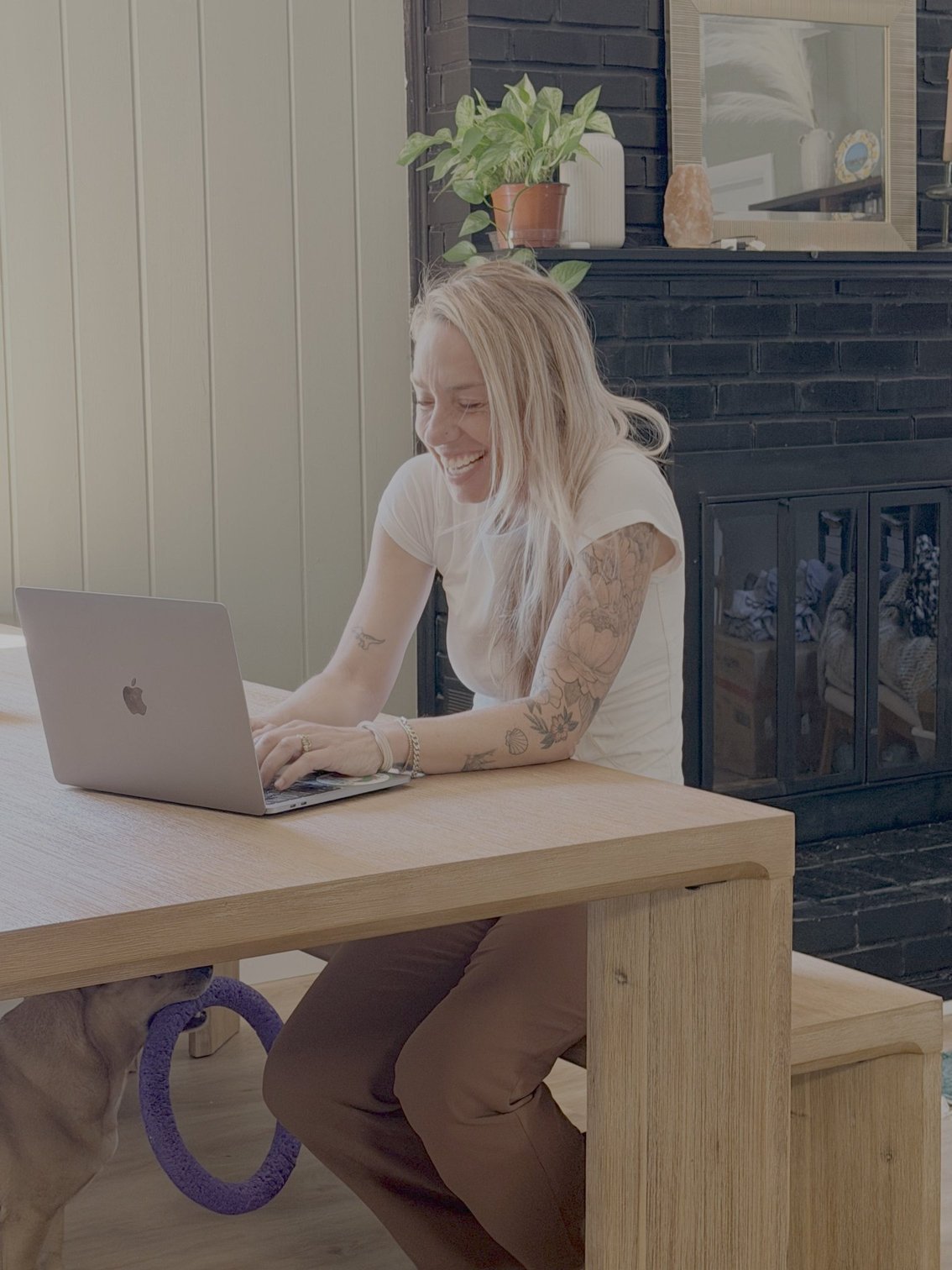 Ash Bergeron working at her laptop, laughing